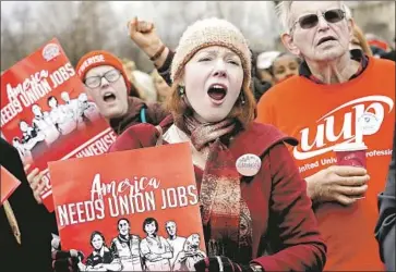  ?? Alex Wong Getty Images ?? THE U.S. Supreme Court’s ruling against the so-called agency fee in public employee union contracts came as little surprise. Above, a pro-union rally is held in front of the court building in Washington in February.