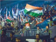  ?? — AFP ?? India’s supporters wave flags and cheer during the semifinal match between India and Thailand of the 2016 Kabaddi World Cup at the Transstadi­a in Ahmedabad on Friday.