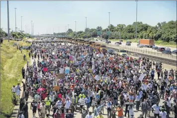  ?? Ashlee Rezin / Chicago Sun-times via Associated Press ?? Thousands of anti-violence protesters pour into the inbound lanes of Interstate 94, known as the Dan Ryan Expressway in Chicago on Saturday.