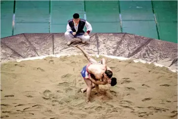  ??  ?? Ssireum wrestlers compete in the 80kg qualifying round during the Korea Open Ssireum Festival in Andong. — AFP photo