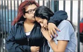  ?? Gary Coronado Los Angeles Times ?? SHELSEA GARCIA, left, and Gemma Martinez mourn for Jesse Romero, who was killed in 2016 by a police officer who believed the 14-year-old fired a revolver.