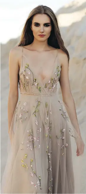  ?? ETSY ?? Embellishm­ents like the beads, silky threads and sequins on this silk, chiffon and tulle gown by Maria Kolomoiets are a big bridal trend.