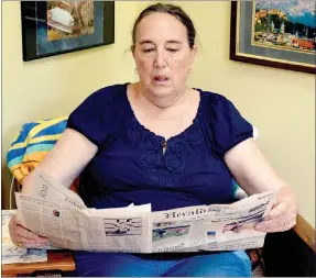  ?? Marc Hayot/Herald-Leader ?? Robbie Castleman reading one of her favorite newspapers.