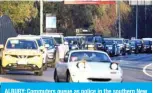  ??  ?? ALBURY: Commuters queue as police in the southern New South Wales (NSW) border city of Albury check cars crossing the state border from Victoria after authoritie­s closed the border due to an outbreak of COVID-19 coronaviru­s in Victoria. — AFP