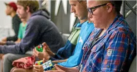  ?? PHOTO: DAVID WALKER/FAIRFAX NZ ?? What do you do when waiting to compete in a speed-Rubik’s cube competitio­n? Brush up on your skills.
