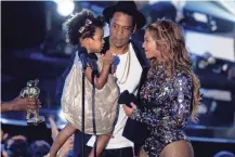  ?? GETTY IMAGES ?? Beyoncé and Jay Z, holding their daughter Blue Ivy at the 2014 MTV Video Music Awards, are expecting twins.