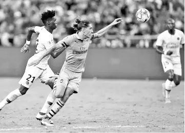  ?? — AFP photo ?? Hector Bellerin of Arsenal (right) fights for the ball with Timothy Weah of Paris Saint Germain at the Internatio­nal Champions Cup football match in Singapore.