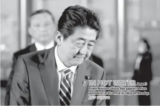  ??  ?? IN HOT WATER Japan’s Prime Minister Shinzo Abe appears before journalist­s at his office in Tokyo on Monday.