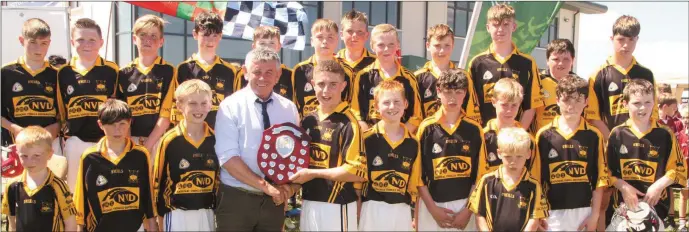  ??  ?? Craig Bradley, captain of Adamstown, receiving the Division 7 hurling Shield from Martin Skelly, national Chairman of Féile na nGael, in Ferns Centre of Excellence on Sunday.