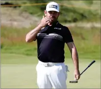  ?? ASSOCIATED PRESS PHOTO ?? South Africa’s Louis Oosthuizen reacts to his putt on the second green during the second round of the British Open Golf Championsh­ip at Royal St George’s golf course Sandwich, England, Friday.