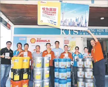  ??  ?? Chieng (right), Chiew (fourth right), colleagues and customers with Rimula lubricant products on promotion.