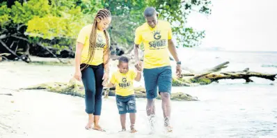  ?? CONTRIBUTE­D PHOTOS ?? Kemar Gayle (left) and Caroney Gregory, who graduated together with Master of Arts degrees with distinctio­n, take a walk at the beach with their four-year-old son Kemarey.
