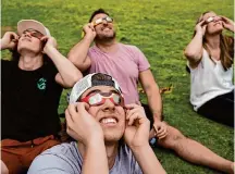  ?? Yi-Chin Lee/Staff photograph­er ?? Vaughn Hilger, from left, Landon Hilger, Brad Hilger and Katie Hilger, all of St. Cloud, Minn., see the solar eclipse in Austin.