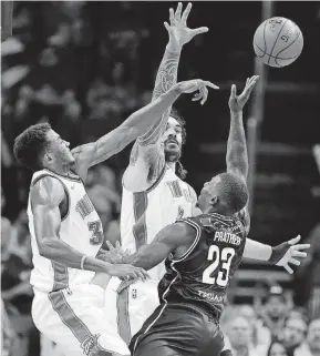  ?? [PHOTO BY SARAH PHIPPS, THE OKLAHOMAN] ?? Josh Huestis, left, and Steven Adams keyed the Thunder’s defensive effort in the fourth quarter of Sunday’s 86-85 exhibition win against Melbourne United at Chesapeake Energy Arena.