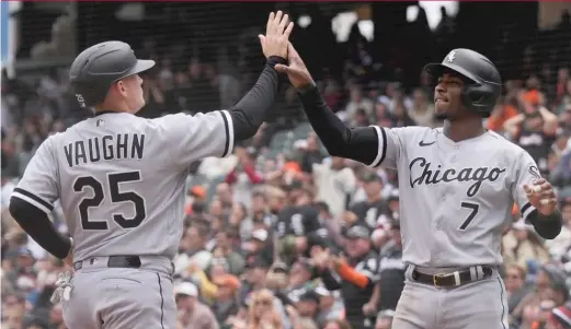  ?? GETTY IMAGES ?? Andrew Vaughn and Tim Anderson share a high-five after they crossed the plate on Gavin Sheets’ double during a three-run fourth inning for the Sox.