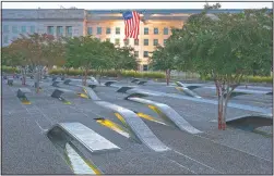  ?? (File Photo/AP/Jacquelyn Martin) ?? A U.S. flag is draped in September 2015 on the side of the Pentagon where the attack took place 14 years earlier, seen from the Pentagon Memorial.