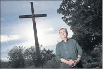  ?? GARY REYES — STAFF ARCHIVES ?? Father Gary Thomas stands in front of the Sacred Heart Catholic Church in Saratoga in 2011. Thomas is the pastor at the church, but he also is the official exorcist of the Diocese of San Jose.