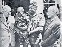  ?? ?? Hennessy (above, with his wife) was used as a sounding board by Idi Amin. Right, the Ugandan leader introduces his son Mwanga to Britain’s foreign secretary James Callaghan (left) and Denis Hills, a lecturer who had been sentenced to death but given a last-minute reprieve