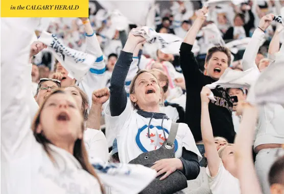  ?? JOHN WOODS / THE CANADIAN PRESS ?? Fans of the Winnipeg Jets celebrate after defeating the Nashville Predators in NHL round-two game seven playoff action in Winnipeg on Thursday.