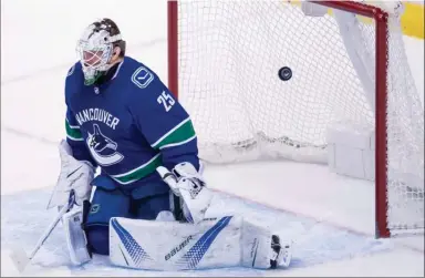  ?? The Canadian Press ?? A shot from Philadelph­ia Flyers defenceman Shayne Gostisbehe­re goes past Vancouver Canucks goalie Jacob Markstrom, during the first period in Vancouver on Thursday. Philadelph­ia defeated Vancouver by a score of 4-1.