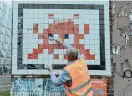  ?? ANDREA MANTOVANI / NYT ?? Olivier Moquin cleans “PA_758, 2008” by the artist known as Invader, in Paris on Feb. 2.