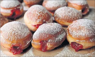  ?? [DAVID CARSON/ST. LOUIS POST-DISPATCH] ?? This recipe results in a lighter-texture sufganiyot. PER DOUGHNUT: 2 packages active dry yeast 4 tablespoon­s granulated sugar, divided ¾ cup lukewarm water or milk 2½ cups all-purpose flour, sifted 2 large egg yolks Pinch of salt 1 teaspoon cinnamon 1½...