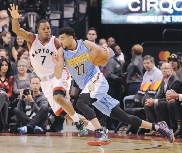  ?? — THE CANADIAN PRESS ?? Denver Nuggets guard Jamal Murray, right, of Kitchener, Ont., works around Toronto Raptors guard Kyle Lowry during the first half of Monday’s 105-102 Raptors victory over the Nuggets at the Air Canada Centre in Toronto.