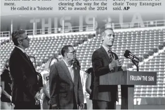  ?? (AP PHOTO/RINGO H.W. CHIU) ?? LOS Angeles Olympic Committee leader Casey Wasserman, from left, and City Council President Herb look on as L.A. Mayor Eric Garcetti speaks during a press conference to make an announceme­nt for the city to host the Olympic Games and Paralympic Games...