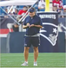  ?? ELISE AMENDOLA/THE ASSOCIATED PRESS ?? “A long way to go,” says Patriots head coach Bill Belichick, who took plenty of notes during practice last Friday. “Just taking it day by day, trying to string some days together and improve from the day before, correct our mistakes and move on here.”