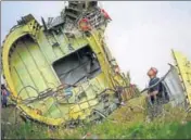  ?? REUTERS FILE ?? ■ An air crash investigat­or inspects the crash site of Malaysia Airlines Flight MH17 in the Donetsk region, Ukraine, in 2014.