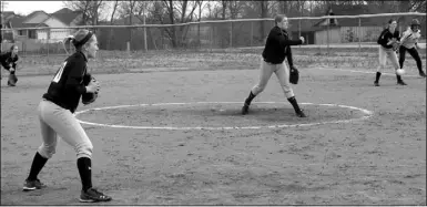  ?? Times photograph­s by Annette Beard ?? Junior Lady ’Hawk Jerika Schooley pitched Friday. Lady ’Hawks Allie VanHouden, first base; Rilee Patrick, second base; and Auti Galvin, third base, readied for defense.