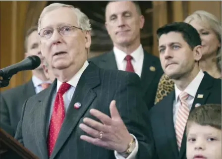  ?? THE ASSOCIATED PRESS ?? House Speaker Paul Ryan and others listen as Senate Majority Leader Mitch McConnell speaks in Washington recently. Republican­s kept control in Congress and adds Republican Donald Trump in the White House on Jan. 20. The GOP plans to undo eight years of...
