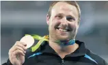  ?? Picture / AP ?? Tom Walsh beat two- time Olympic champion Tomasz Majewski and former world champion David Storl to win bronze.