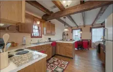  ??  ?? Nearly 190-year-old beams cross the ceiling of an apartment inside the Mainstay Bed &amp; Breakfast.