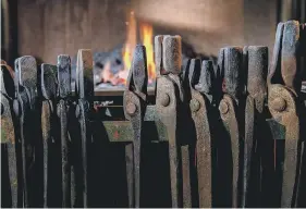  ??  ?? BURNING LOVE: From top, David hard at work in his smithy at Lockton with hammer and anvil along with some examples of his handiwork and, bottom, some of the tools of his metalwork trade.