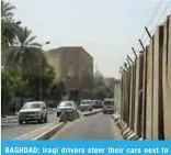  ??  ?? BAGHDAD: Iraqi drivers steer their cars next to cement blocks on Aug 5, 2018. — AFP