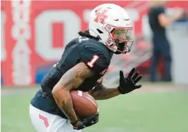  ?? MICHAEL WYKE/AP ?? Houston wide receiver Nathaniel Dell recorded 108 catches for 1,399 yards and a nation-leading 17 touchdowns in 2022.