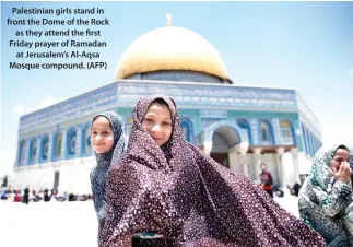  ??  ?? Palestinia­n girls stand in front the Dome of the Rock as they attend the first Friday prayer of Ramadan at Jerusalem’s Al-Aqsa Mosque compound. (AFP)