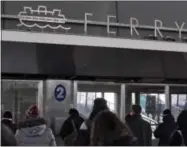  ?? RICHARD DREW — THE ASSOCIATED PRESS ?? Passengers wait for a Staten Island Ferry in the St. George Ferry Terminal, in the Staten Island borough of New York on Thursday.