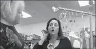  ?? Raleigh News & Observer/VIRGINIA BRIDGES ?? Donna Hankin, (right) who co-owns Joint Venture Jewelry and Peachy Keen in Cary, N.C., shows earrings to customer Beverly Byrd.