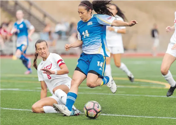  ?? — WILSON WONG/UBC ATHLETICS ?? Simon Fraser’s Teagan Sorokan, left, slows the progress of UBC’s Shayla Chorney during the first non-spring women’s soccer clash between the crosstown rivals in eight seasons Saturday atop Burnaby Mountain. UBC scored late to earn a 1-1 draw.