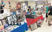  ?? BRIAN BALLOU/STAFF ?? Items for sale at the People’s Convention in Margate this weekend included vintage comic books, action hero figures and art and sports memorabili­a.