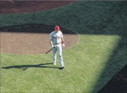  ?? WINSLOW TOWNSON — THE ASSOCIATED PRESS ?? Philadelph­ia Phillies’ J.T. Realmuto heads back to the dugout after striking out during the seventh inning of a baseball game against the Boston Red Sox Wednesday at Fenway Park in Boston.