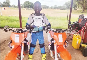  ?? ?? MOST PRIZED POSSESSION . . . Young motocross rider Victor Nyamupfuku­dza cannot hide his excitement after receiving two brand new KTM 65cc bikes from Harare businessma­n and politician Scott Sakupwanya
