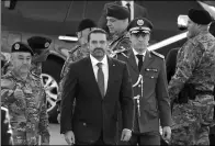  ?? MOHAMED AZAKIR/ REUTERS ?? Lebanese PM Saad al-Hariri attends a military parade in Beirut on Wednesday. Hariri, who announced his resignatio­n in a Nov 4 broadcast from Saudi Arabia, said he has delayed his decision at the request of President Michel Aoun to allow for dialogue.