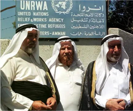  ?? (Reuters) ?? PALESTINIA­NS STAND in front of an UNRWA building. The Trump administra­tion has done the right thing when it comes to UNRWA and other issues, the author argues.