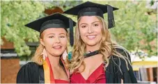  ??  ?? Brittany Gannon (left) and Maddy Hill celebrate their graduation from USQ yesterday.