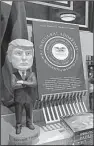  ?? The Washington Post/ MICHAEL E. MILLER ?? A President Donald Trump bobblehead doll sits among other presidenti­al offerings at the National Archives gift shop in Washington.