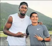  ??  ?? Nisar Ahmed (right) with Usain Bolt in Jamaica.