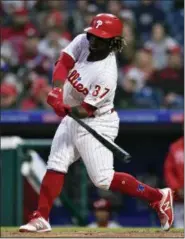  ?? DERIK HAMILTON — THE ASSOCIATED PRESS ?? The Phillies’ Odubel Herrera hits a three-run home run off Atlanta Braves’ Julio Teheran during the first inning of a baseball game, Friday in Philadelph­ia.